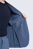 Navy blue sayki slim fit performance suit jacket with notch lapel and subtle stitching for smart casual wear