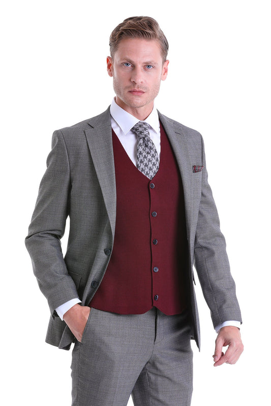 Man wearing a gray checkered suit jacket over a maroon vest and white dress shirt.
