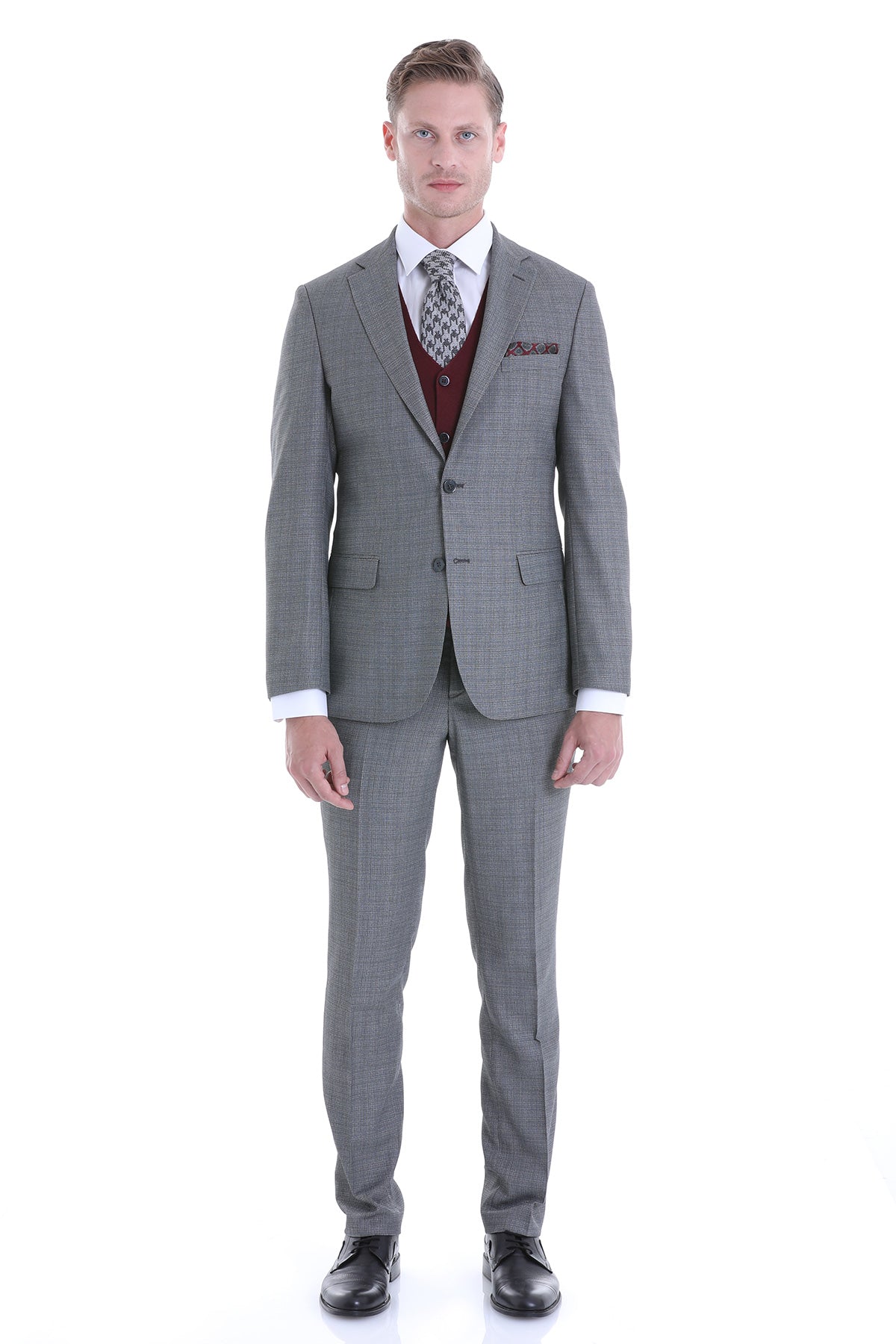 Gray checkered men’s suit with a matching vest and patterned tie.