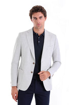Light gray tailored blazer with subtle texture and matching brown buttons.