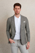 Gray textured blazer with a subtle pattern, worn over a white polo shirt.