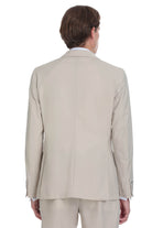 Beige tailored suit jacket with subtle vertical seam and matching cuffs.