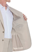 Beige skins performance suit jacket with subtle stitching and button details.
