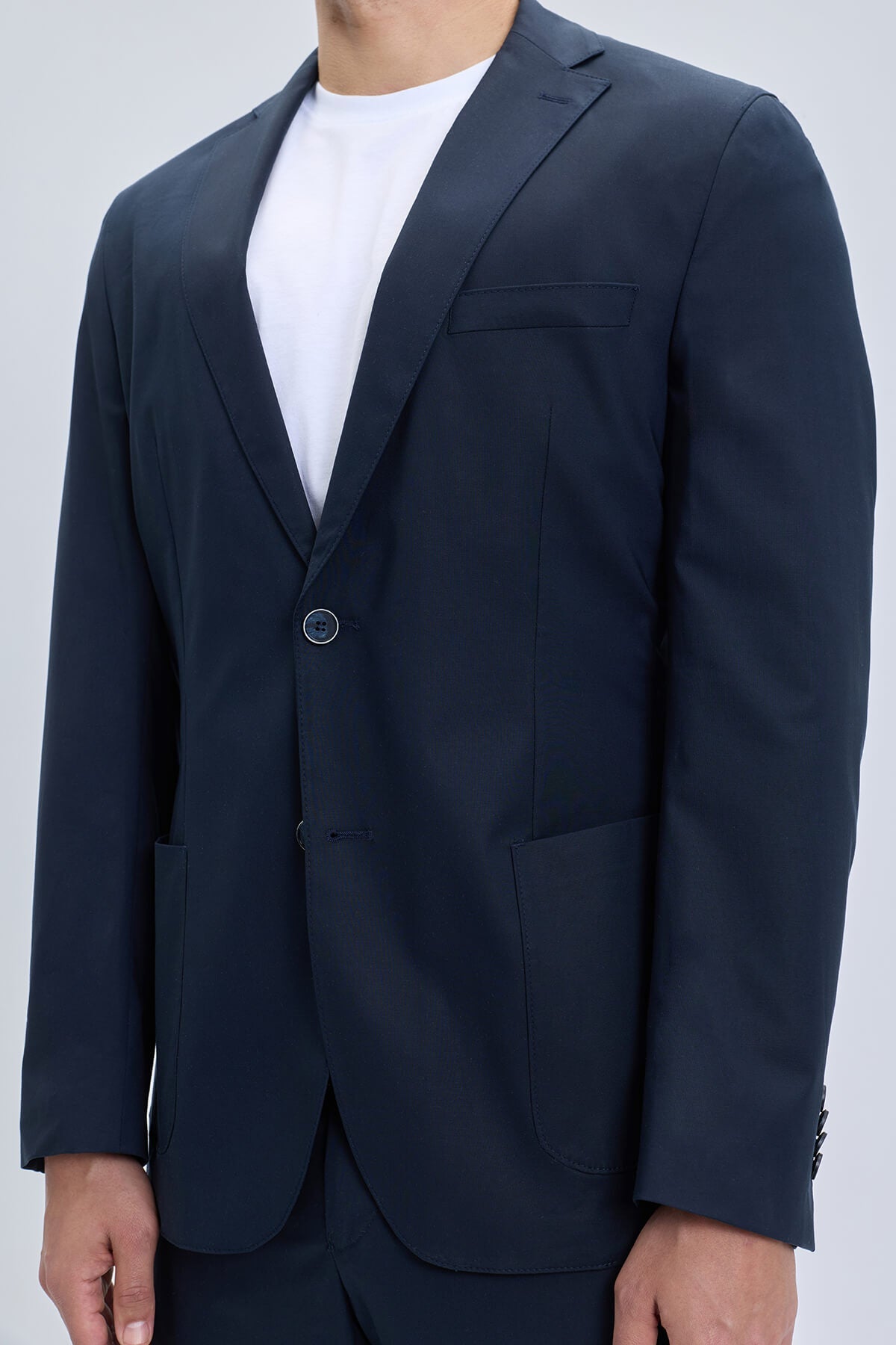 Navy slim fit notch lapel blazer with single button closure and structured lapels in lightweight casual suit