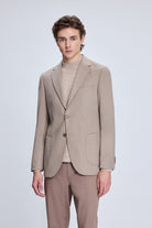 Beige double-breasted blazer with a subtle texture and matching trousers.