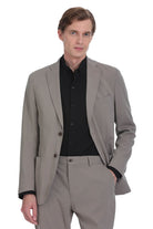A tailored beige suit jacket with a sleek, modern cut and black inner lining.