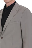 A sleek, light gray men’s blazer with a subtle textured weave and a single button closure.