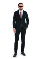 Black tailored suit with a subtle texture, paired with a patterned tie and matching trousers.