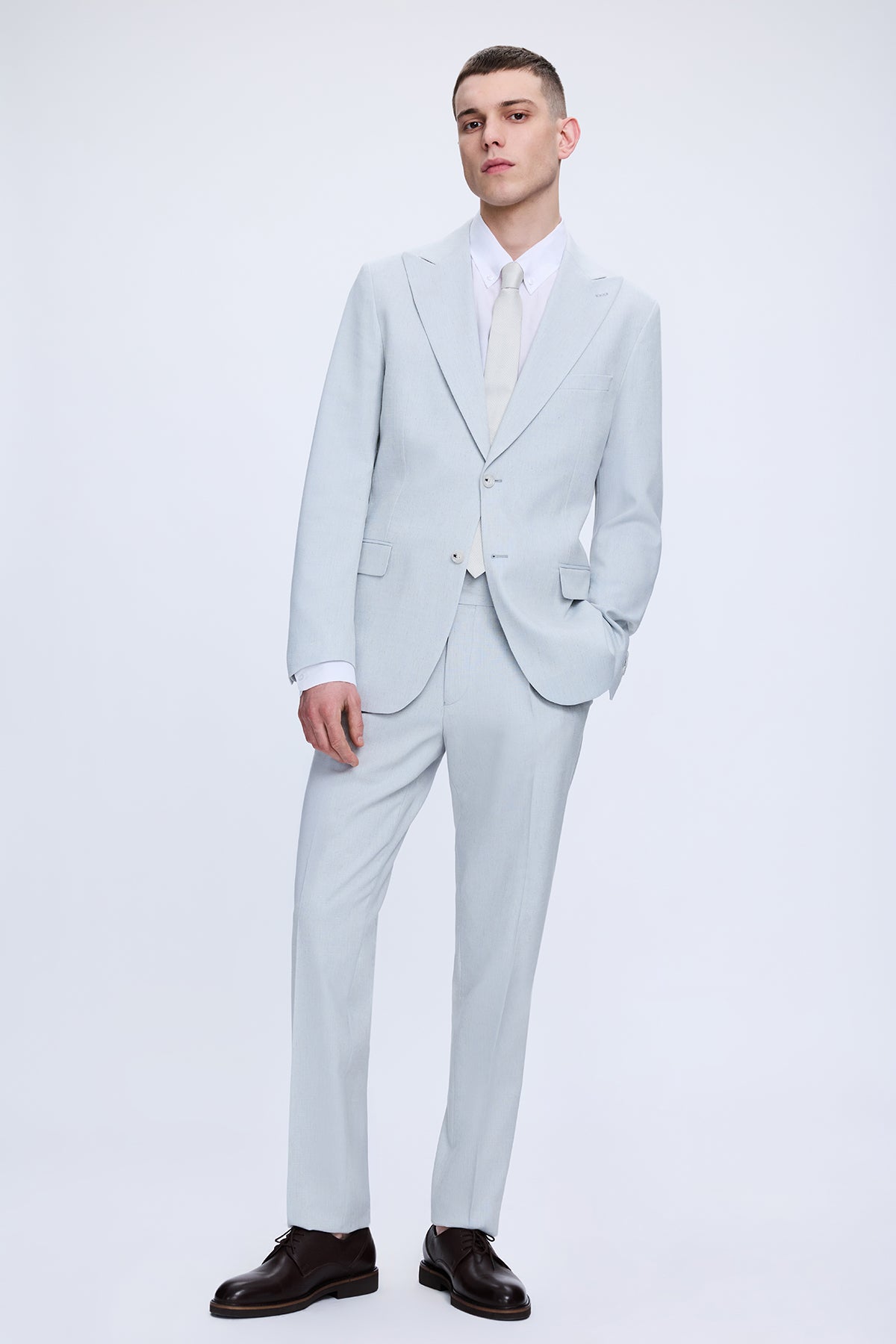 Slim fit peak lapel light blue linen-cotton suit with tailored fit and subtle texture for stylish formal wear