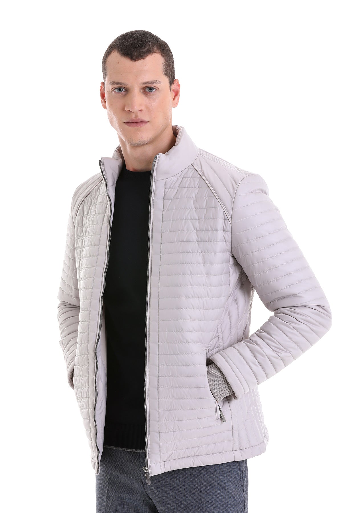 Light gray quilted men’s jacket with a stand-up collar and zipper closure.