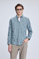 A men’s long-sleeved button-up shirt in a green and white plaid pattern, made of lightweight fabric with neatly finished cuffs.
