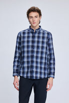A navy and white plaid long-sleeved button-up shirt with a classic collar.