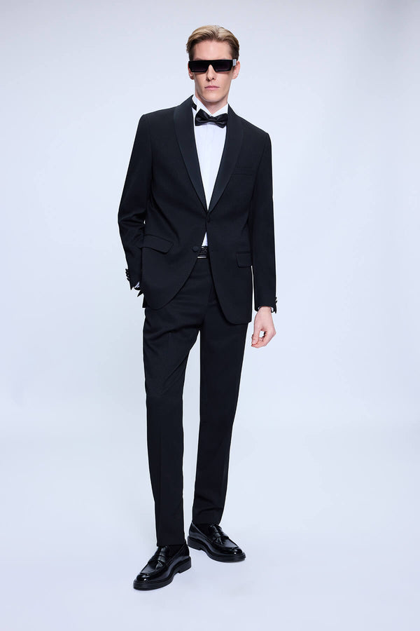 Black tuxedo suit with notched lapels and matching trousers.