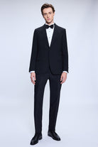 Black tailored tuxedo suit with notched lapels and matching trousers.