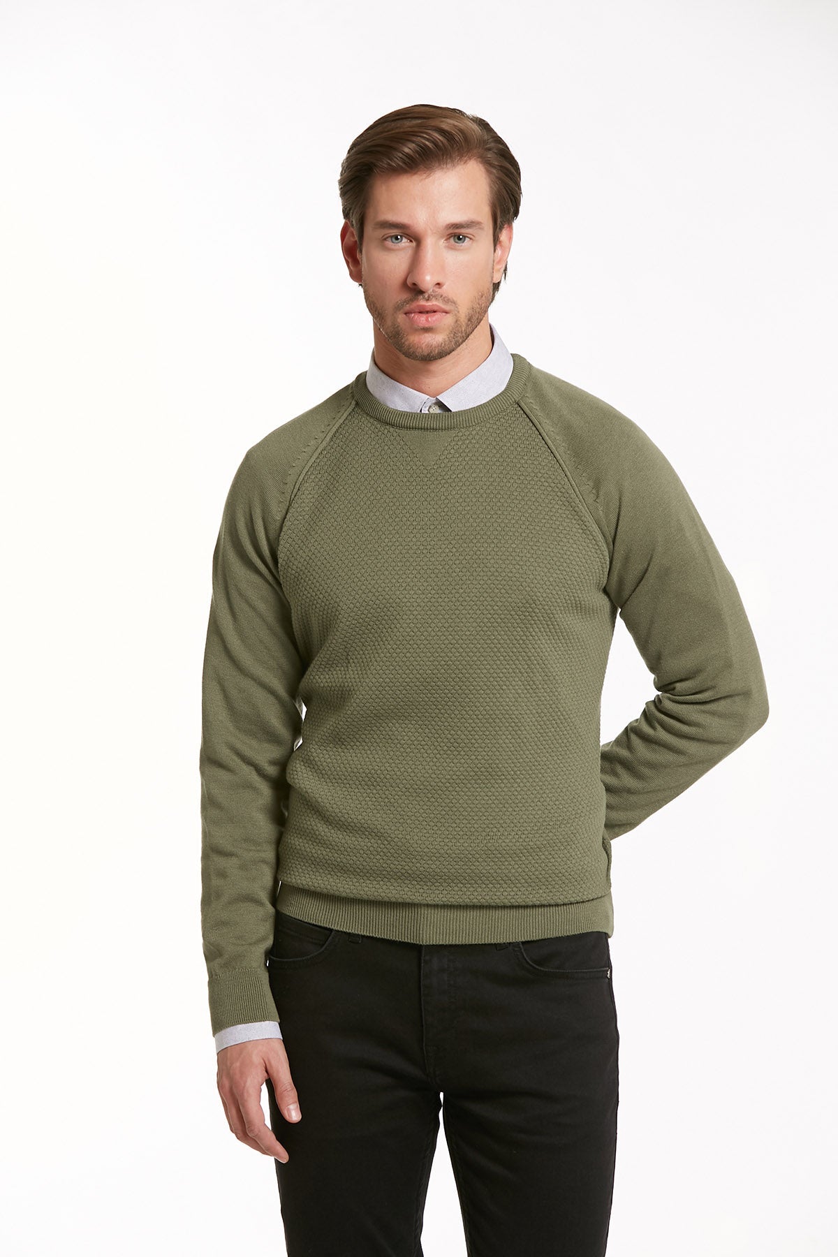 Olive green textured knit sweater with raglan sleeves and ribbed cuffs.