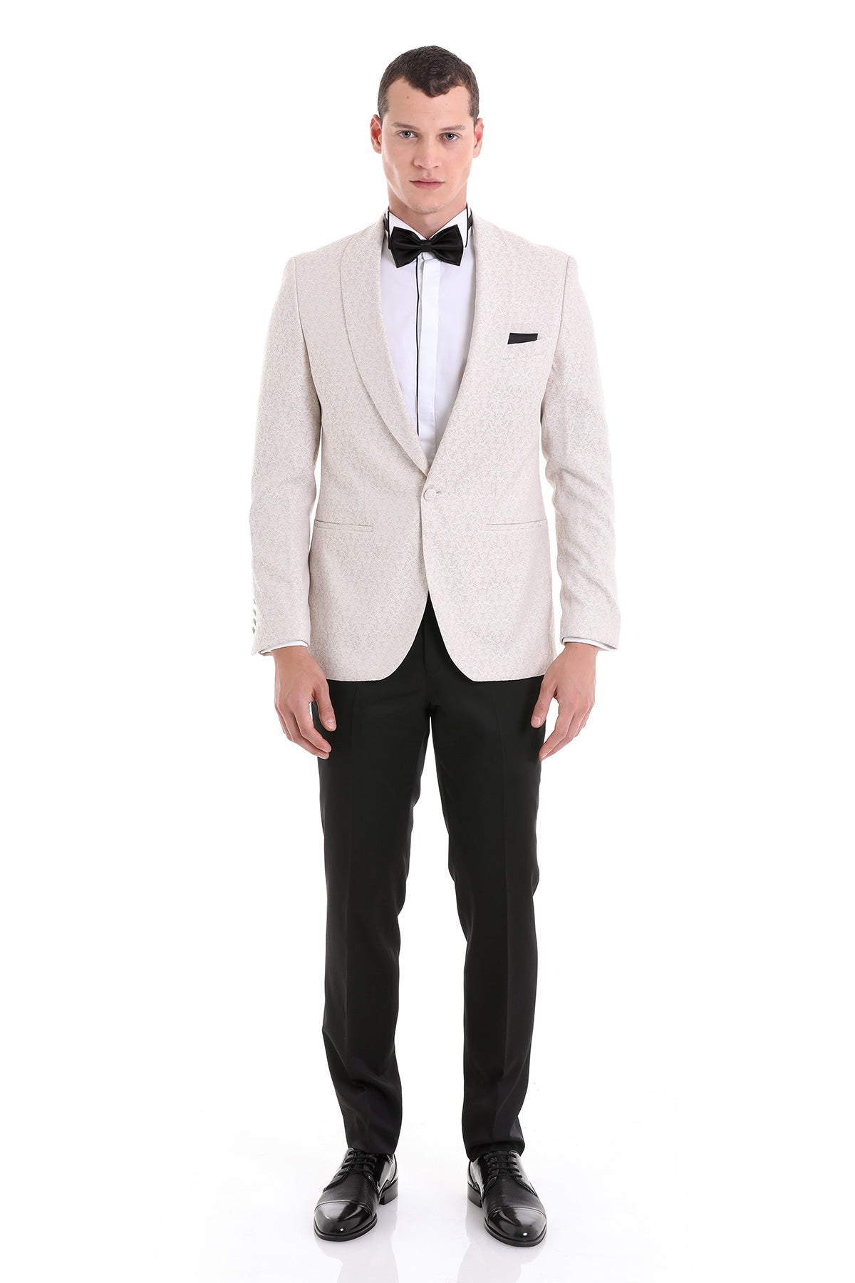 Slim fit cream tuxedo jacket with floral jacquard texture and shawl lapel paired with black trousers