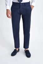 Navy blue slim-fit chinos with a subtle texture and matching button closure
