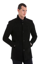 Black woolen men’s coat with a stand-up collar and front button closure.