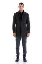 Black men’s tailored coat with a structured collar and front button closure.