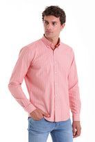 A pink long-sleeved button-down shirt with thin white vertical stripes.