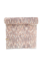 A soft, rolled-up pink and gray abstract patterned fabric scarf with a subtle textured weave.