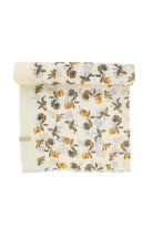 A soft, cream-colored scarf with a delicate floral pattern in shades of yellow and muted gray.