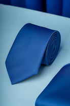 A sleek, solid royal blue silk tie with a subtle woven texture.