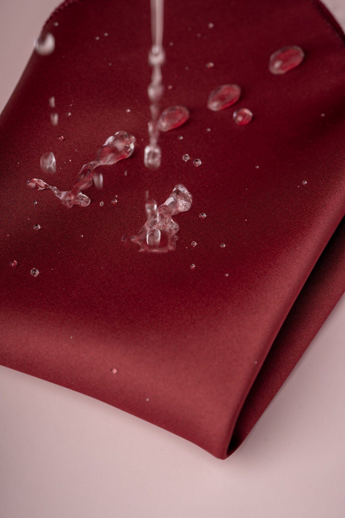 A rich burgundy satin napkin with a smooth, glossy finish.