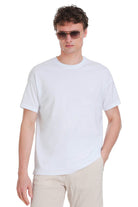 White oversize cotton crew neck t-shirt with subtle embroidered logo on the left chest