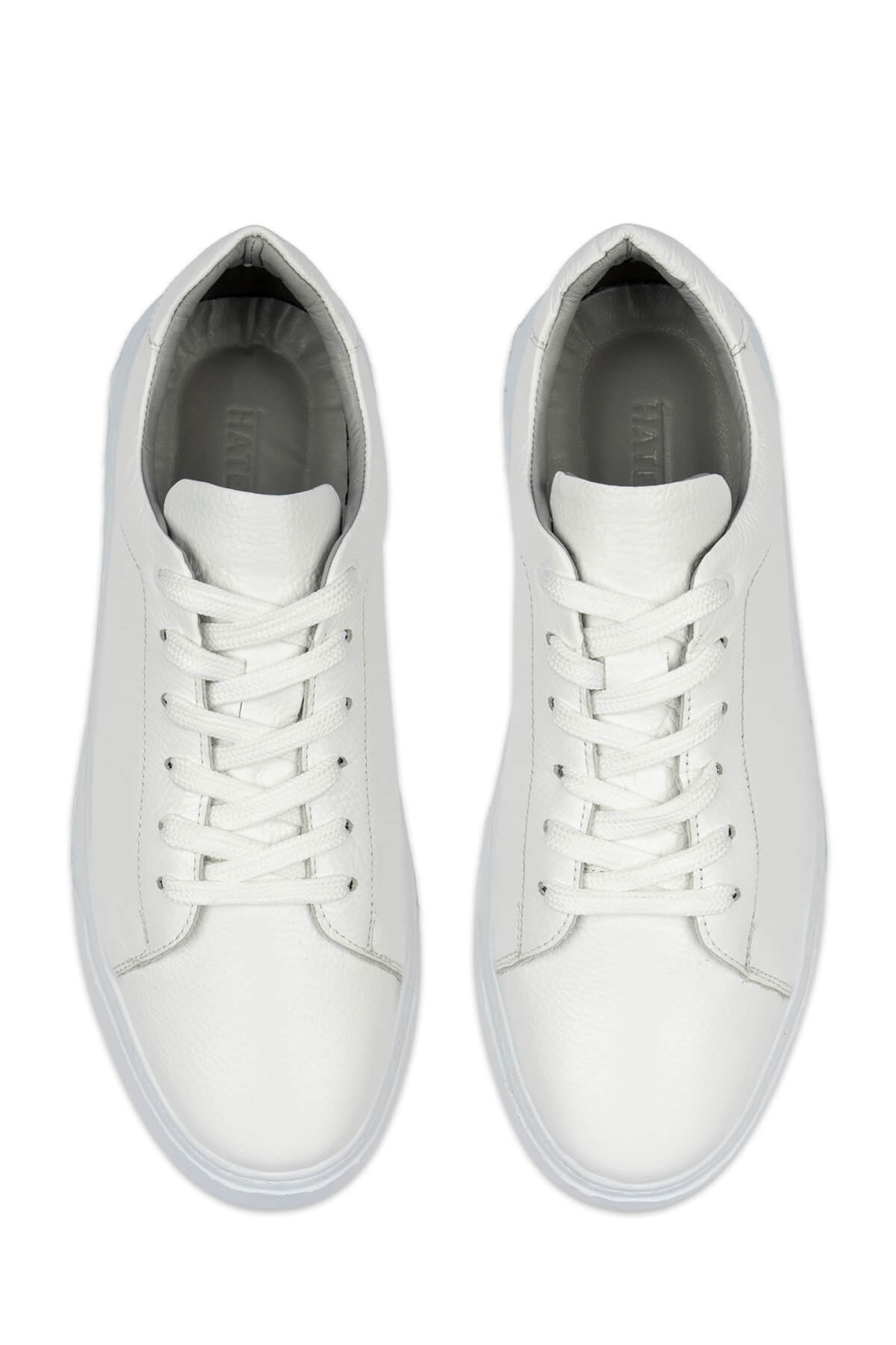 White leather low-top sneakers with matching laces and a clean, minimalist design.