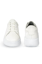 White leather sneakers with a clean, minimalist design and chunky soles.